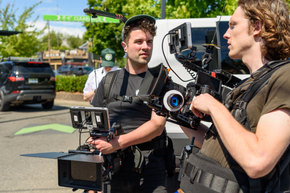 Behind the scenes images of Petting Zoo team holding cameras on set.