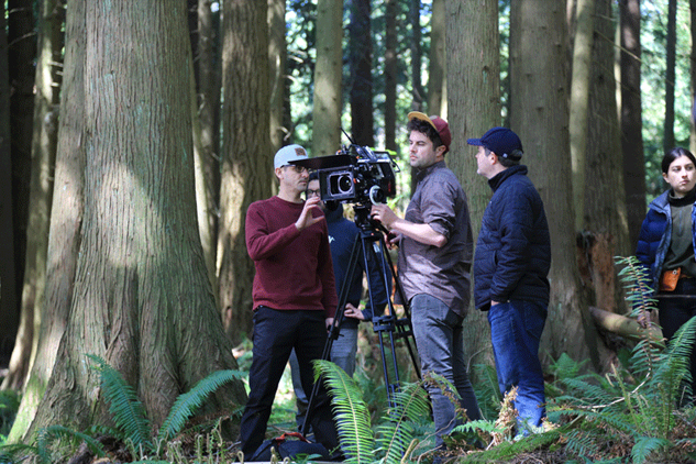 Camera operators in forested scene shooting Rainier spots.