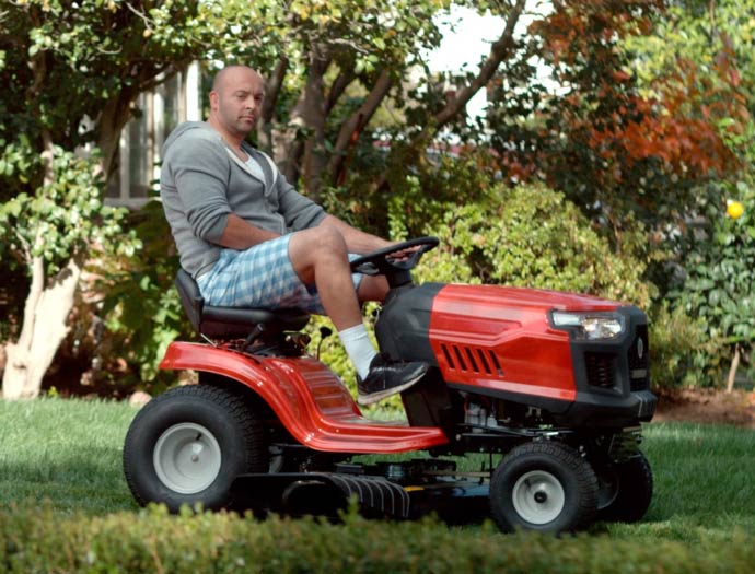 Man riding a lawnmower.